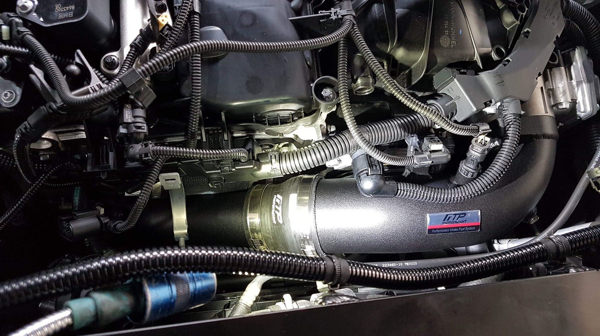Black FTP B58 Gen 2 charge pipe fitted beside the throttle body