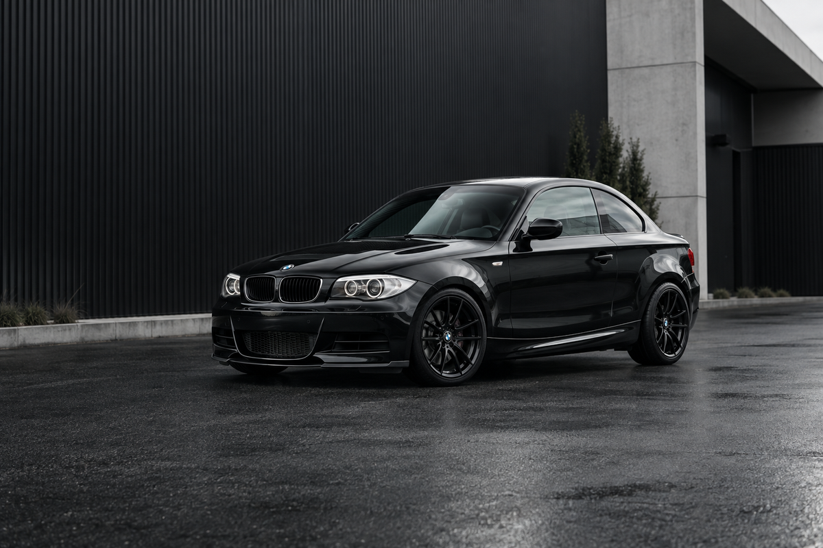 Illustration of a lowered gloss-black BMW E82 135i